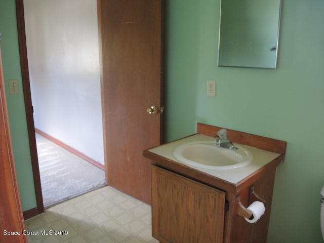 6990 Boston Road Cocoa, FL 32927 - Photo 18 of 26 a bathroom with a sink and a mirror