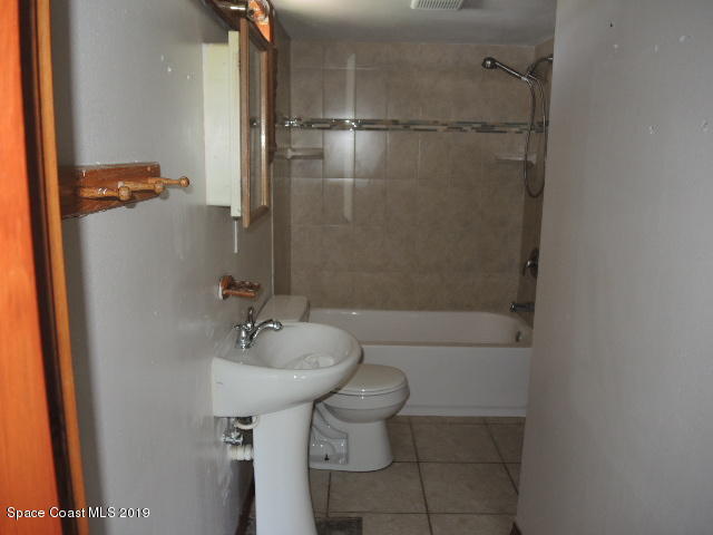 6990 Boston Road Cocoa, FL 32927 - Photo 22 of 26 a bathroom with a sink toilet and shower