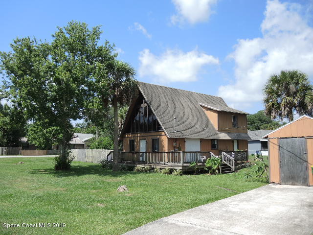 6990 Boston Road Cocoa, FL 32927 - Photo 4 of 26 a front view of a house with a yard