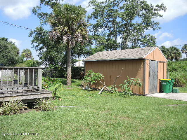 6990 Boston Road Cocoa, FL 32927 - Photo 5 of 26 a view of house with backyard and outdoor seating