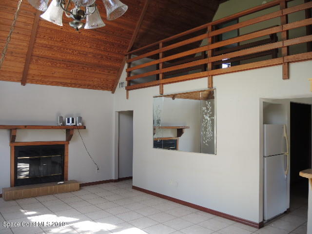 6990 Boston Road Cocoa, FL 32927 - Photo 8 of 26 a view of a room with a fireplace