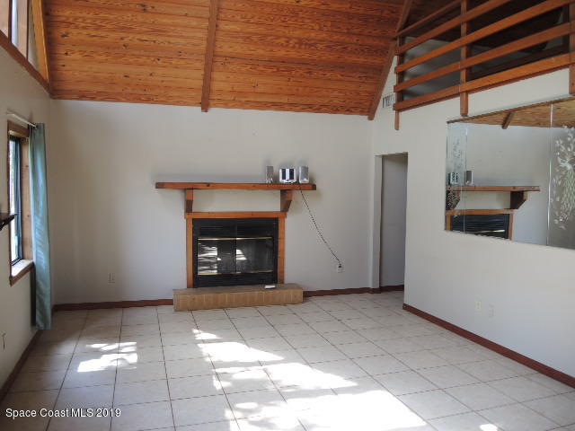 6990 Boston Road Cocoa, FL 32927 - Photo 9 of 26 a view of an empty room with a fireplace