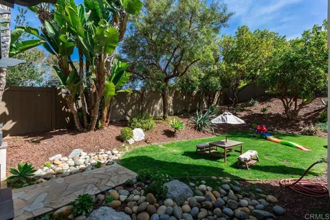 a view of a patio with table and chairs potted plants