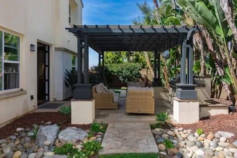 a view of the patio with couches and a fire pit