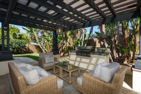 a living room with patio furniture and a large window