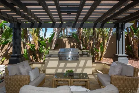 a view of a dining room with furniture and a potted plant