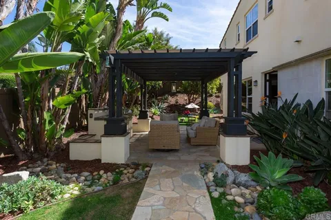 a backyard of a house with outdoor seating