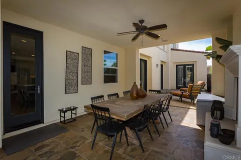 an aerial view of residential houses with outdoor space and trees