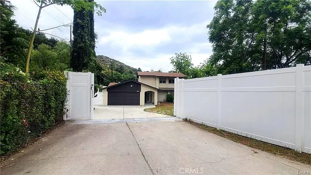 a view of a house with a yard and garage