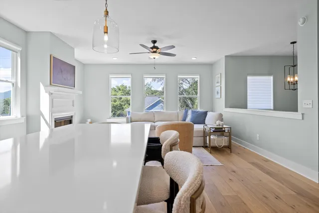 a kitchen with stainless steel appliances granite countertop a white cabinets and a refrigerator