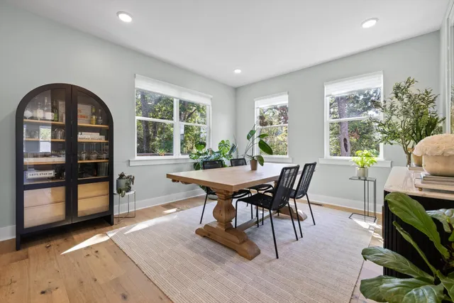 a bathroom with a granite countertop sink a mirror and shower