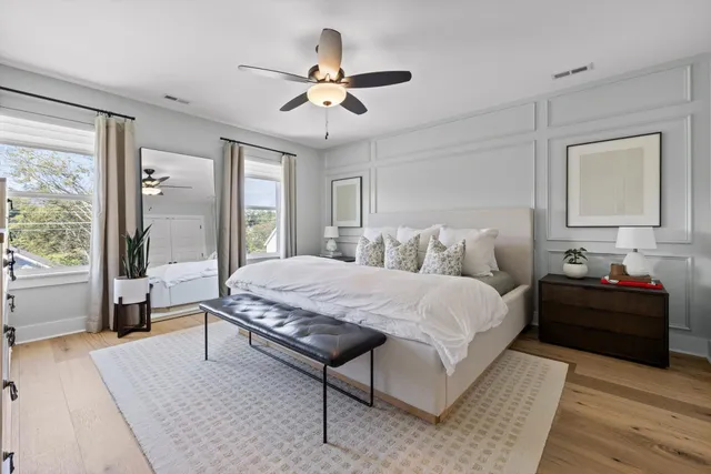 a bedroom with a bed and wooden floor