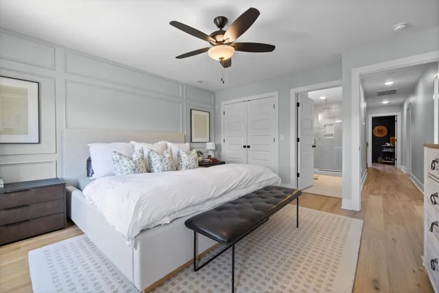 a bedroom with a bed and a ceiling fan