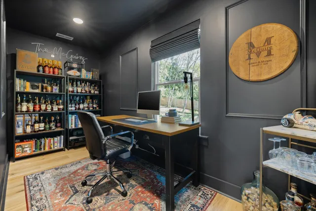 a view of a bedroom with workspace and a window
