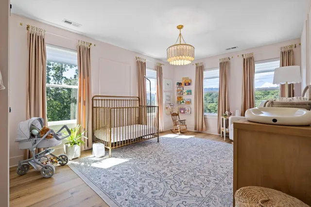 a view of a couches in the deck under a large tree