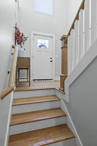 a living room with furniture a window and wooden floor