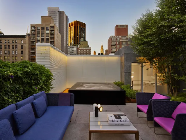 a view of city from balcony with seating space