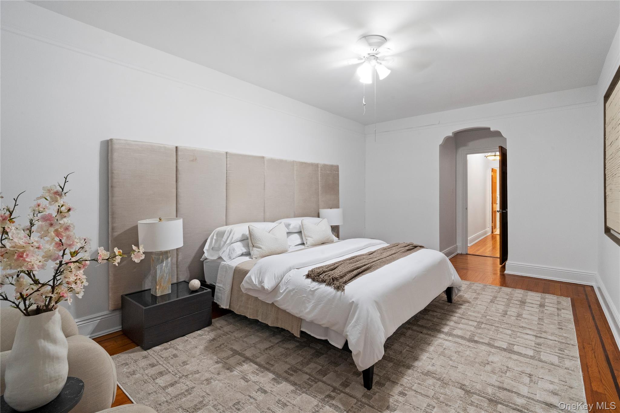 110-21 73rd Road, Unit 5H Queens, NY 11375 - Photo 11 of 14 a bedroom with a bed and a chandelier