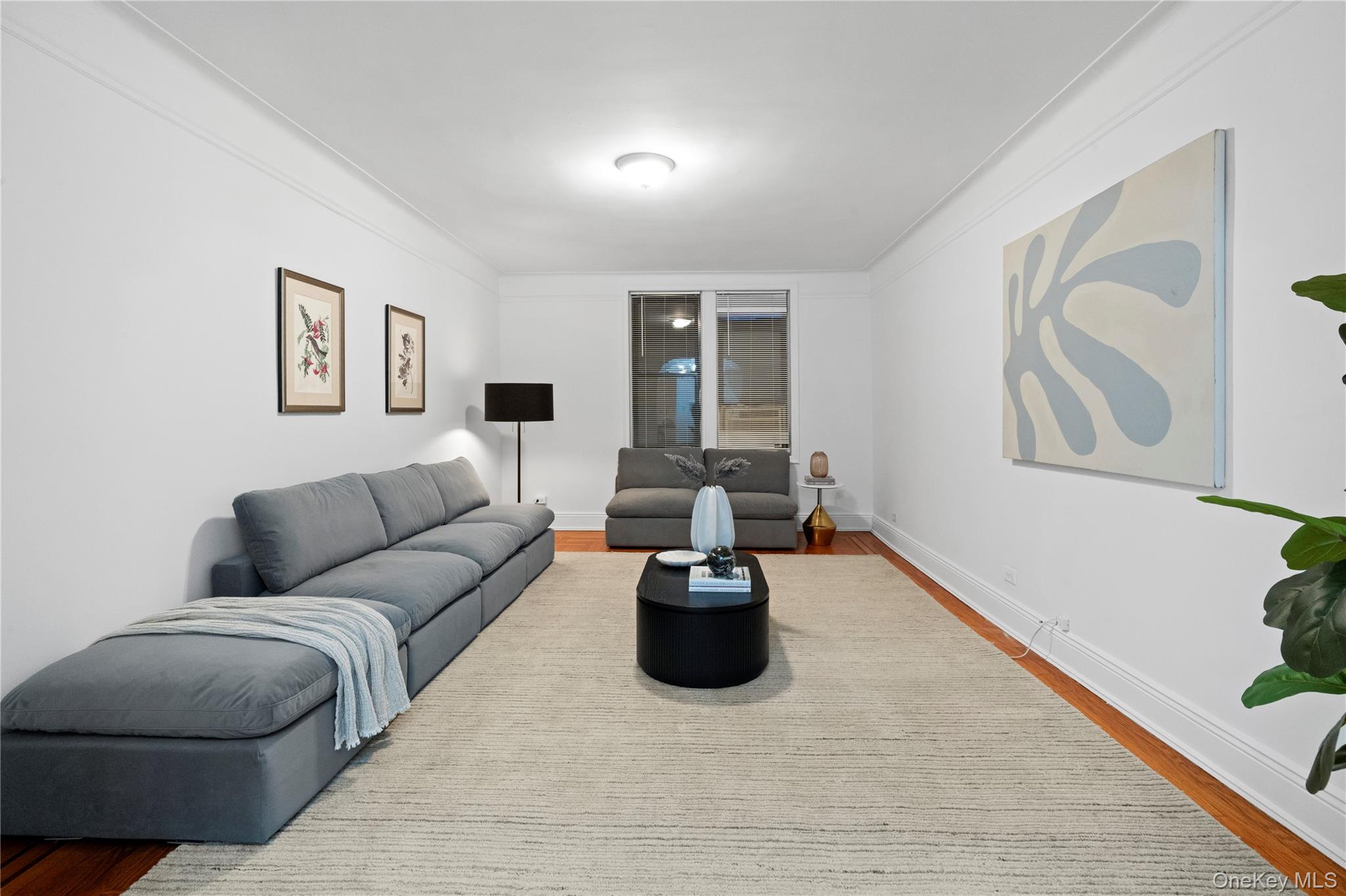 110-21 73rd Road, Unit 5H Queens, NY 11375 - Photo 2 of 14 a living room with furniture and a wooden floor