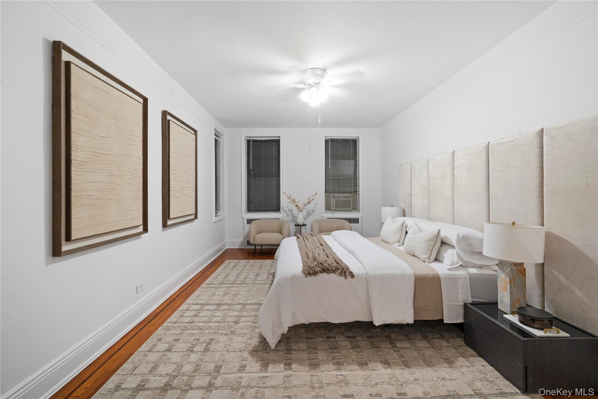 110-21 73rd Road, Unit 5H Queens, NY 11375 - Photo 10 of 14 a bed room with a bed and a chandelier