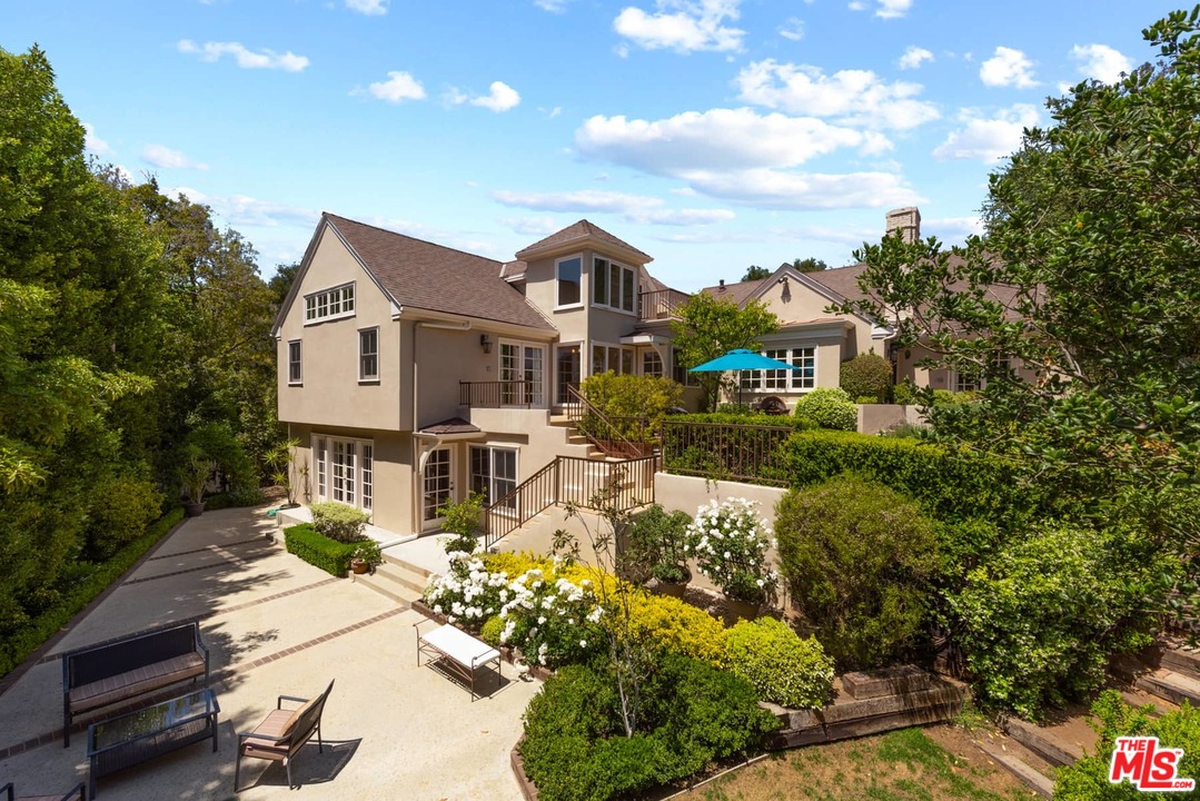 1020 Casiano Road Los Angeles, CA 90049 - Photo 1 of 31 a front view of a house with a yard and lake view