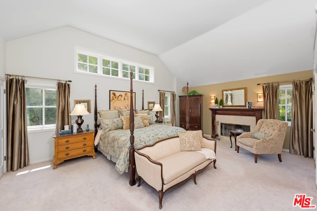 1020 Casiano Road Los Angeles, CA 90049 - Photo 11 of 31 a bedroom with a balcony a bed and a couch