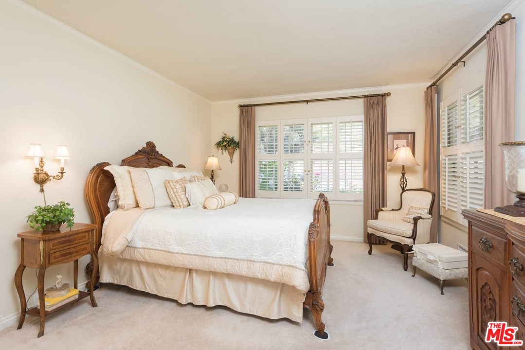 1020 Casiano Road Los Angeles, CA 90049 - Photo 13 of 31 a bedroom with a bed chair and a large window