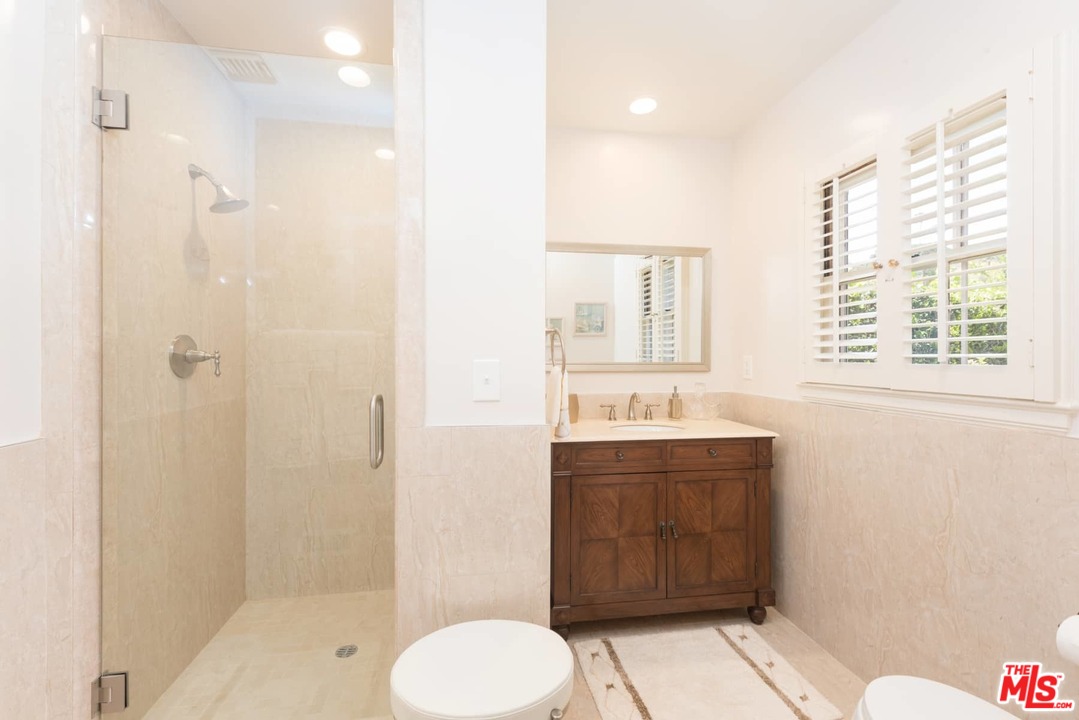 1020 Casiano Road Los Angeles, CA 90049 - Photo 14 of 31 a bathroom with a sink a toilet and shower