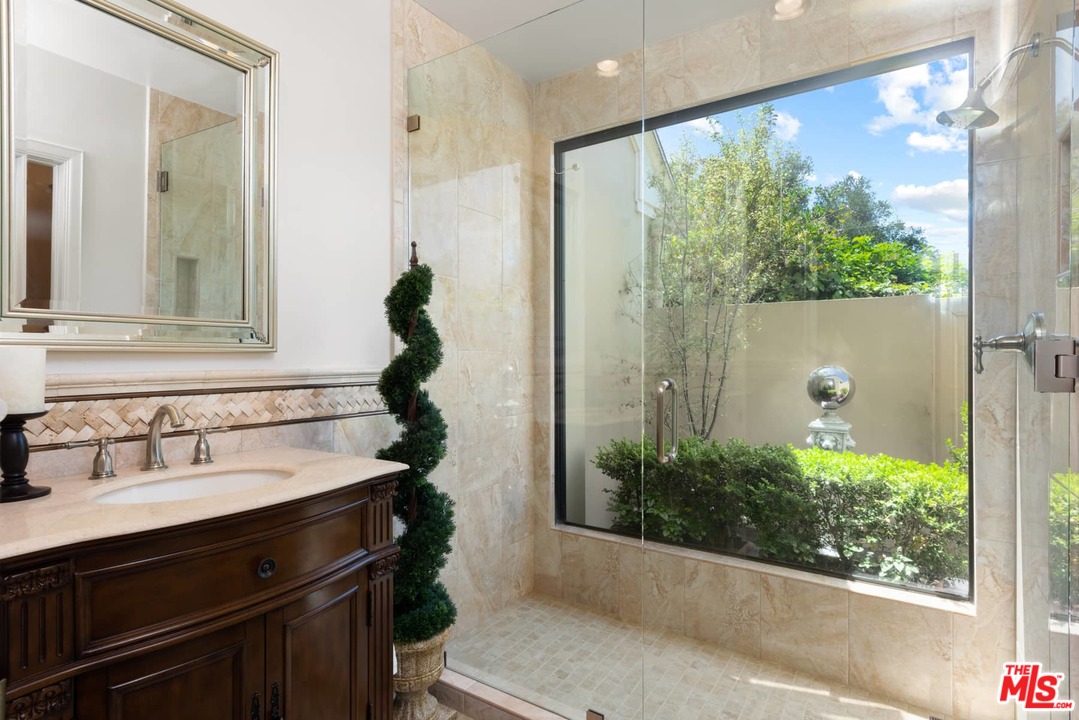 1020 Casiano Road Los Angeles, CA 90049 - Photo 17 of 31 a bathroom with a sink and a mirror