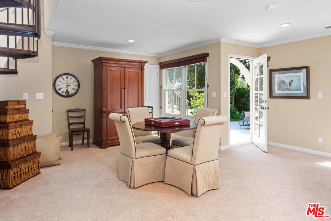 1020 Casiano Road Los Angeles, CA 90049 - Photo 19 of 31 a living room with furniture a window and a clock