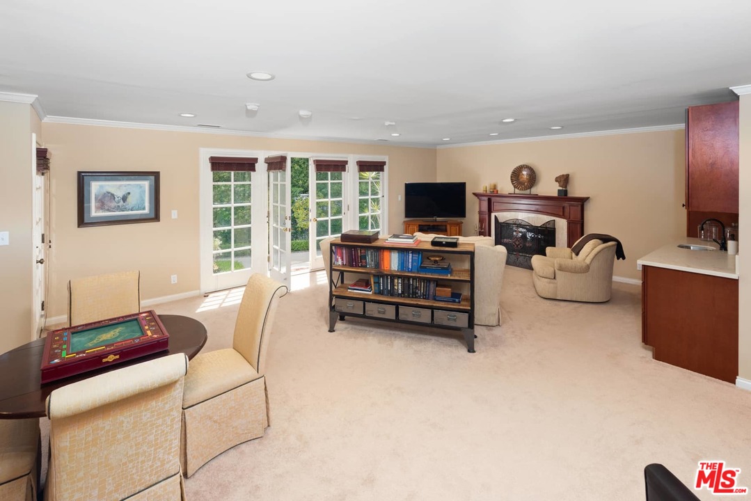 1020 Casiano Road Los Angeles, CA 90049 - Photo 21 of 31 a living room with furniture a flat screen tv and a window