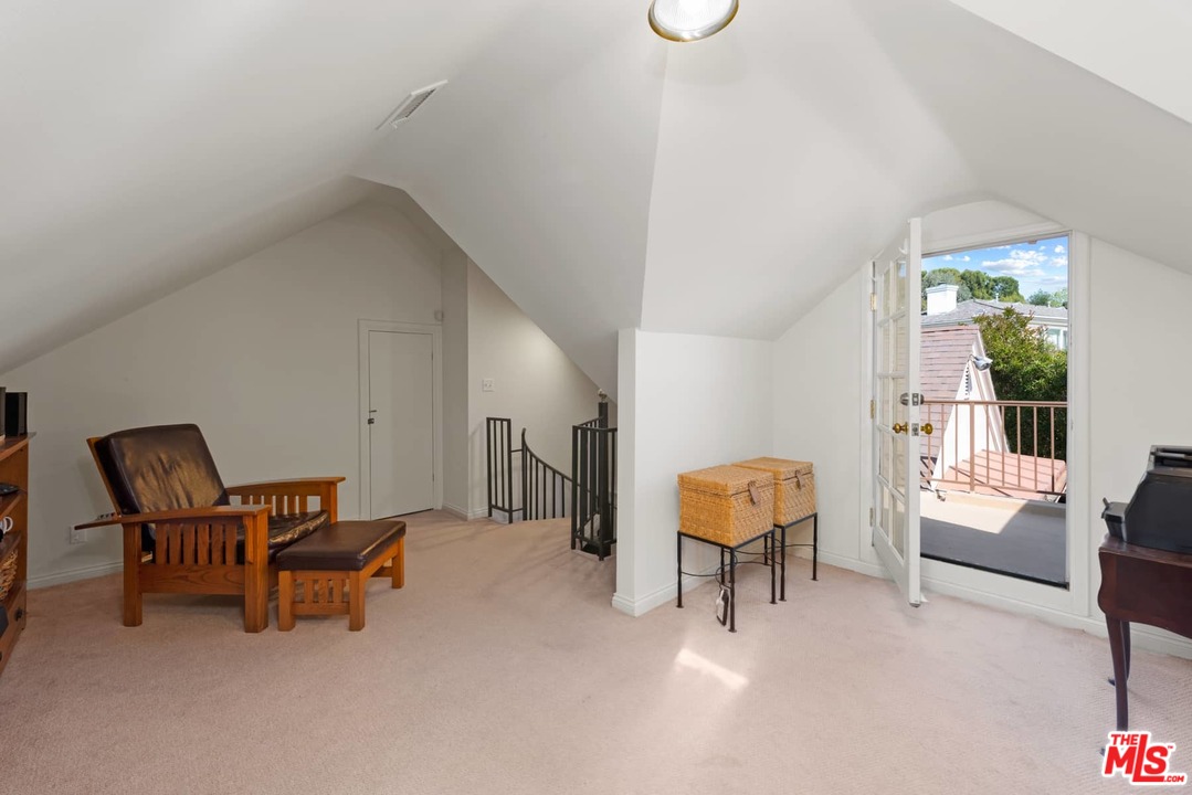 1020 Casiano Road Los Angeles, CA 90049 - Photo 23 of 31 a living room with furniture and a chair
