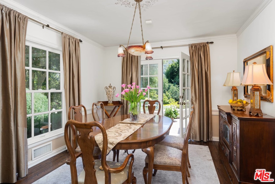1020 Casiano Road Los Angeles, CA 90049 - Photo 7 of 31 a dining room with furniture a chandelier and wooden floor