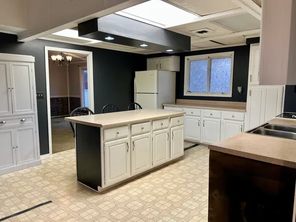 a kitchen with a sink stove and cabinets