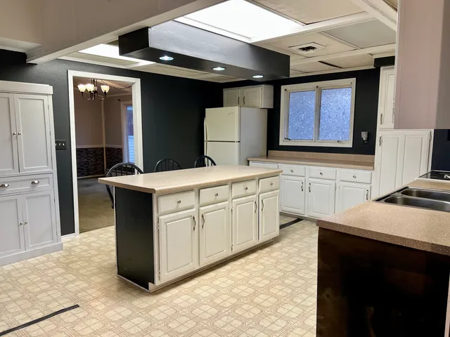 a kitchen with a sink stove and cabinets