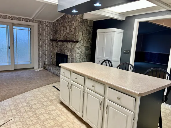 a kitchen with a sink a mirror and a refrigerator
