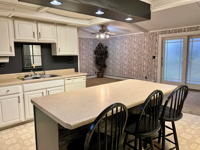 a kitchen that has a table and chairs in it