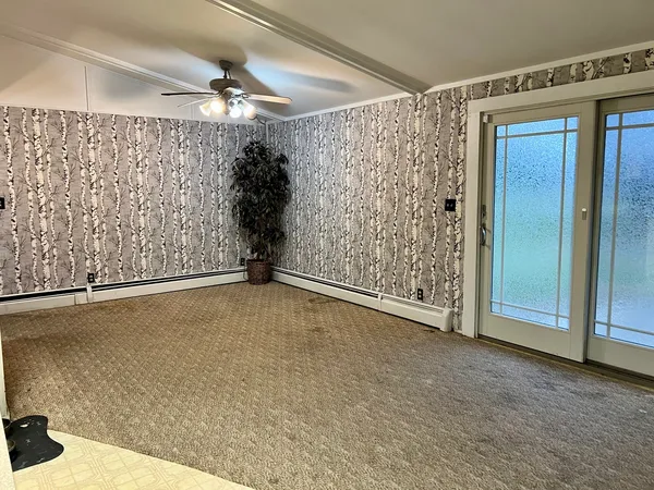 a view of an empty room with a window