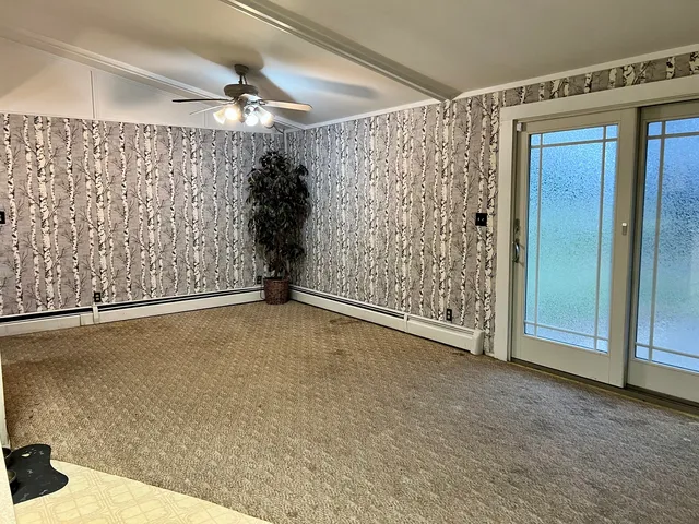 a view of an empty room with a window