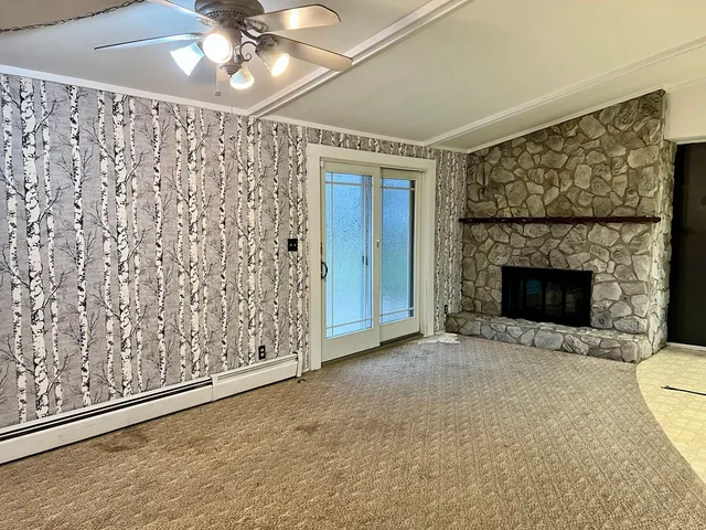 a view of an empty room with a fireplace