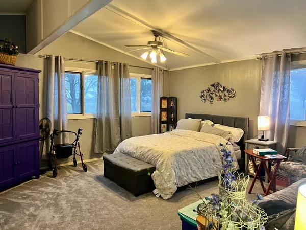 a bedroom with a bed and a chandelier