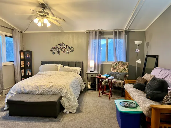 a bedroom with a bed and ceiling fan