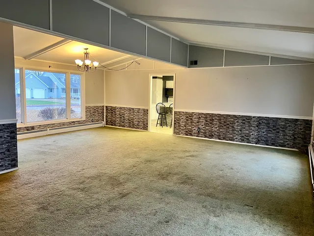 a view of an empty room with a fireplace