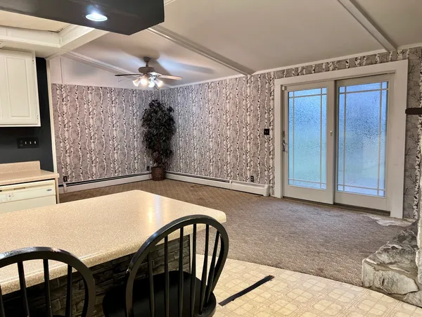 a dining room with furniture and window