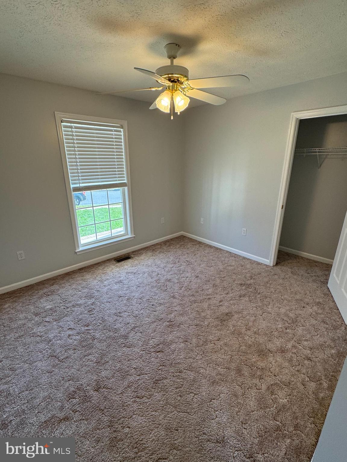 34 Stuart Court Strasburg, VA 22657 - Photo 30 of 54 an empty room with a chandelier fan and windows