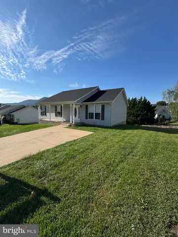 a view of house with yard and green space