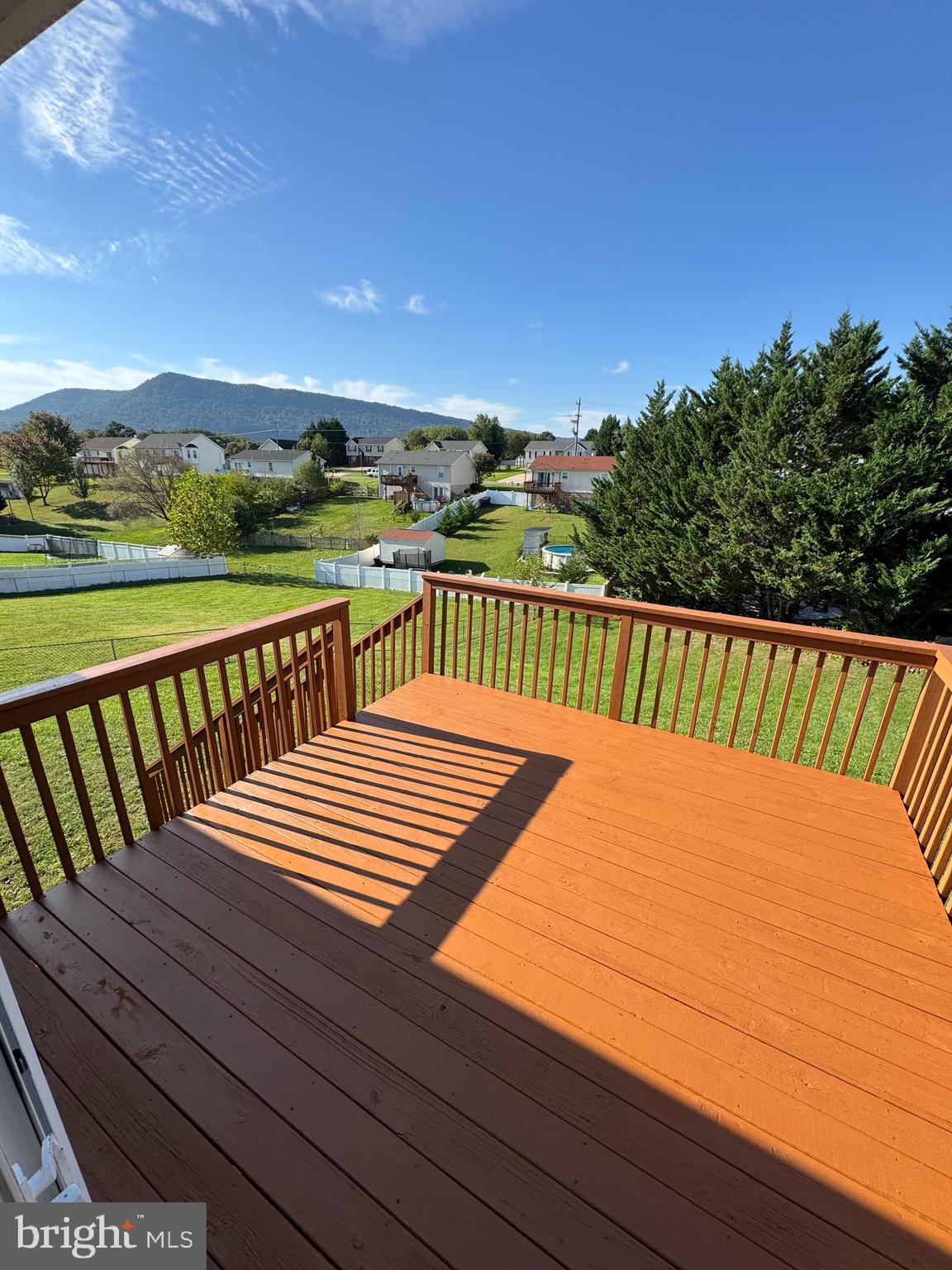 34 Stuart Court Strasburg, VA 22657 - Photo 5 of 54 a view of a balcony with wooden floor and fence