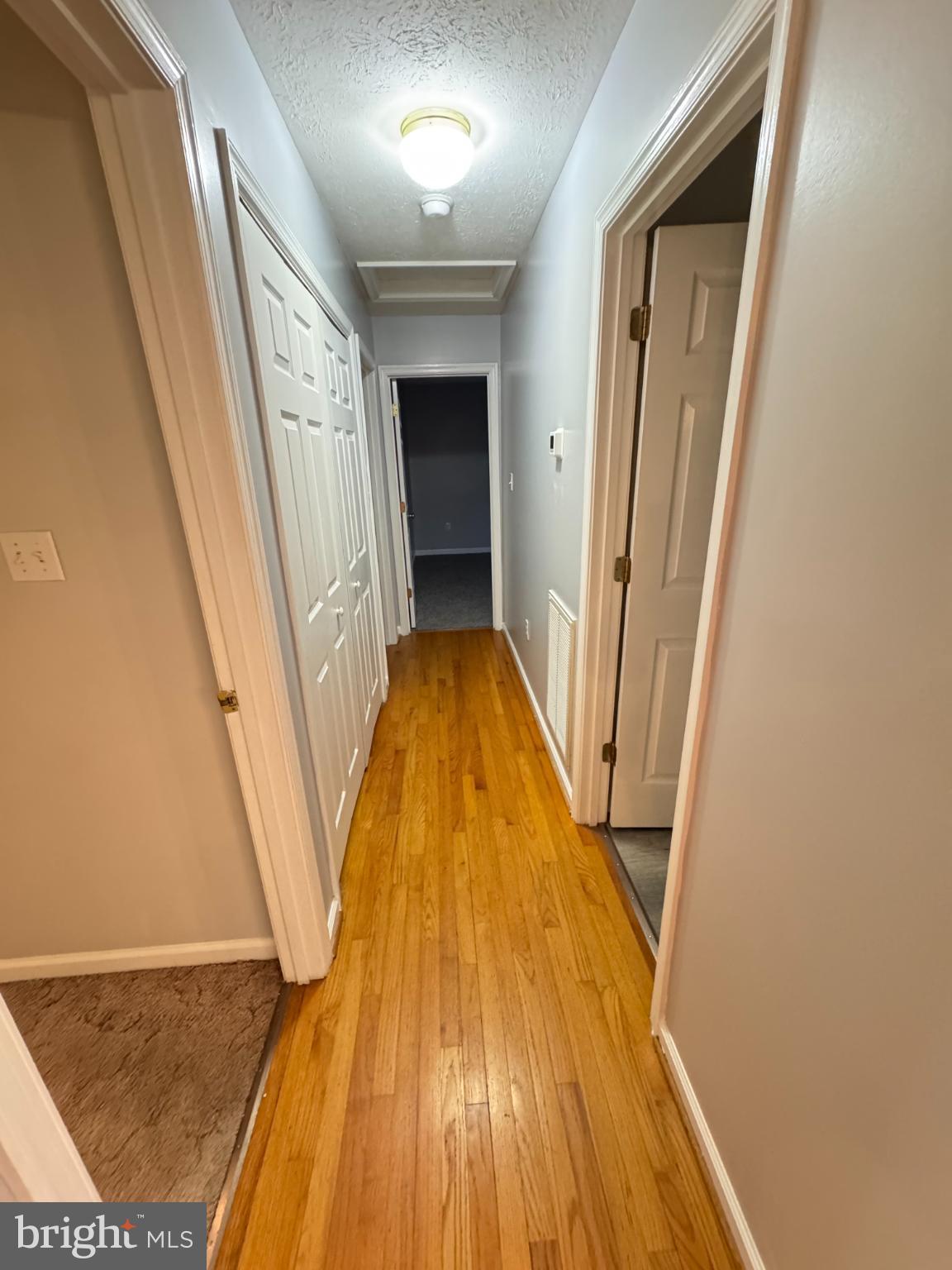 34 Stuart Court Strasburg, VA 22657 - Photo 53 of 54 a view of a hallway with wooden floor
