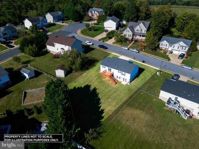 an aerial view of a house swimming pool a yard and a garden