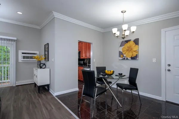 a view of a dining room with furniture and chandelier